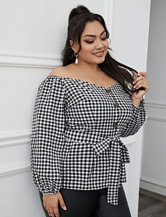 person wearing the black checker-patterned top