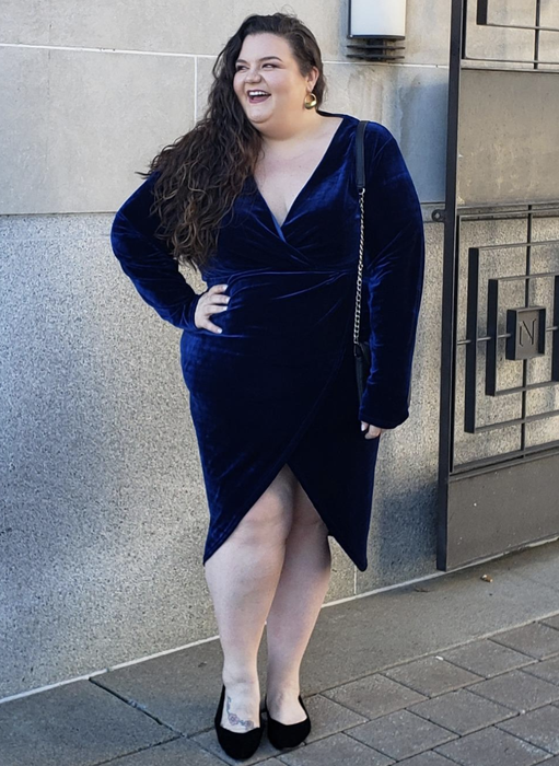 A reviewer wearing the stunning blue velvet dress