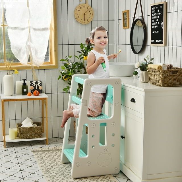 A child kneeling on a mostly white step stool