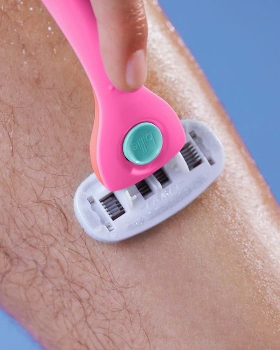 a model using a pink and orange razor