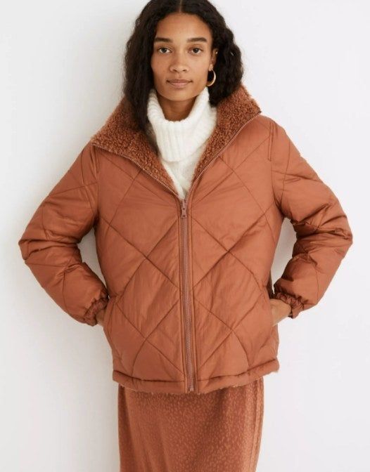 A model showcasing the jacket flipped around, with the Sherpa on the inside and the waterproof exterior facing out.