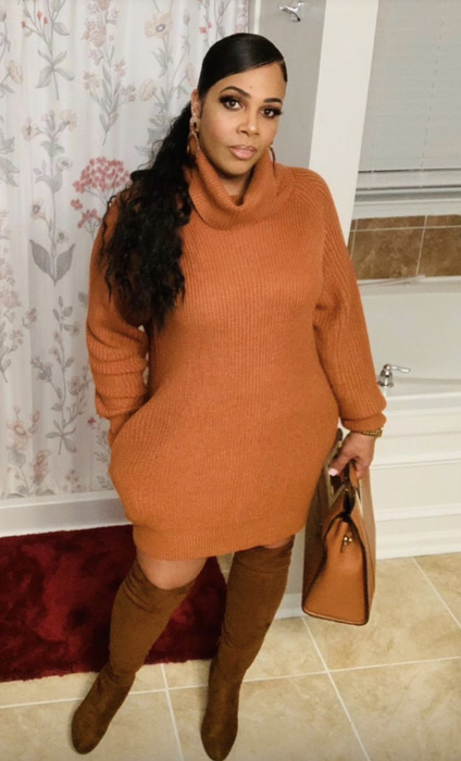 reviewer wearing the orange dress