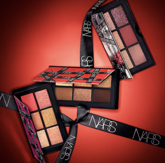 The three different color eyeshadow palettes are elegantly arranged with ribbons that read