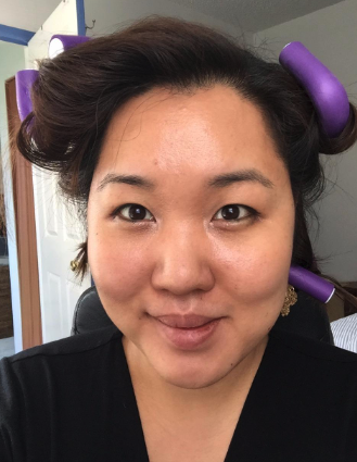 a reviewer with purple twist flex rods in their hair