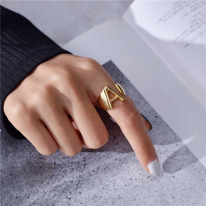 person wearing an A initial ring