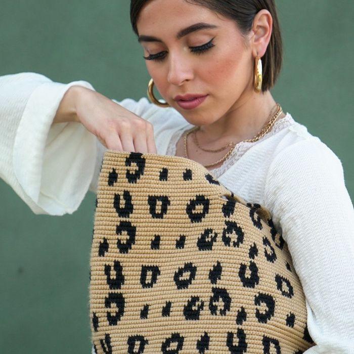 model holding a leopard-print shopper bag