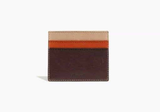 The card holder features a dark brown bottom, an orange middle, and a tan top, blending bold colors with practicality.