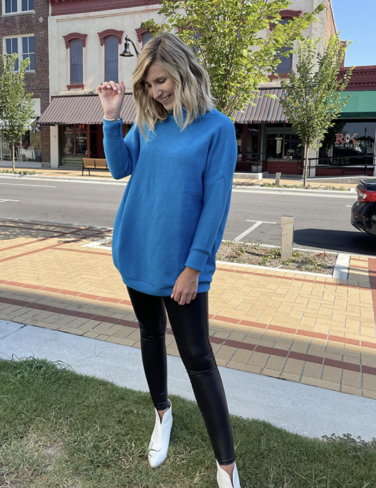 reviewer showcasing the blue sweater