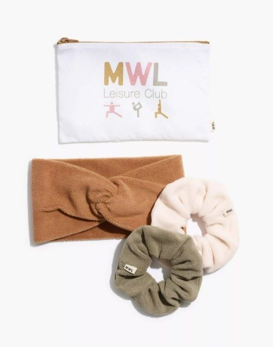 the gift set includes one green and one white scrunchie, a brown knotted headband, and a zippered pouch with the words 