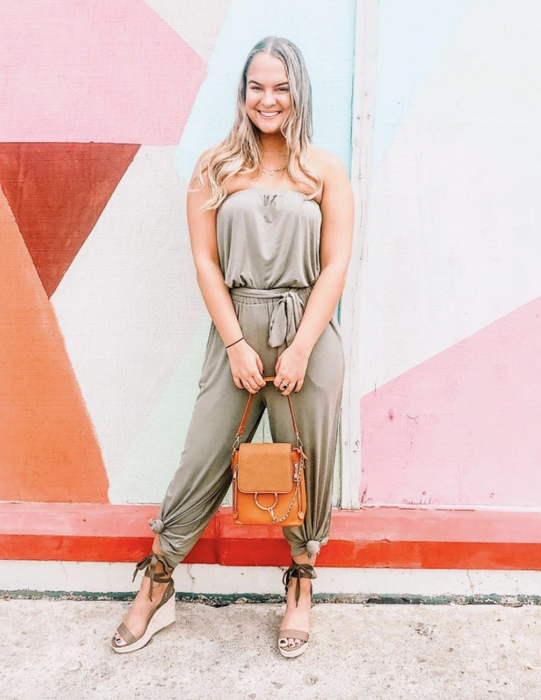 reviewer showcasing the olive green jumpsuit with ankle ties