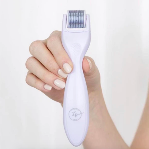 Handheld roller with small needles on its rolling top.