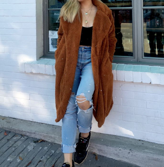 reviewer showcasing the jacket with jeans and a black top