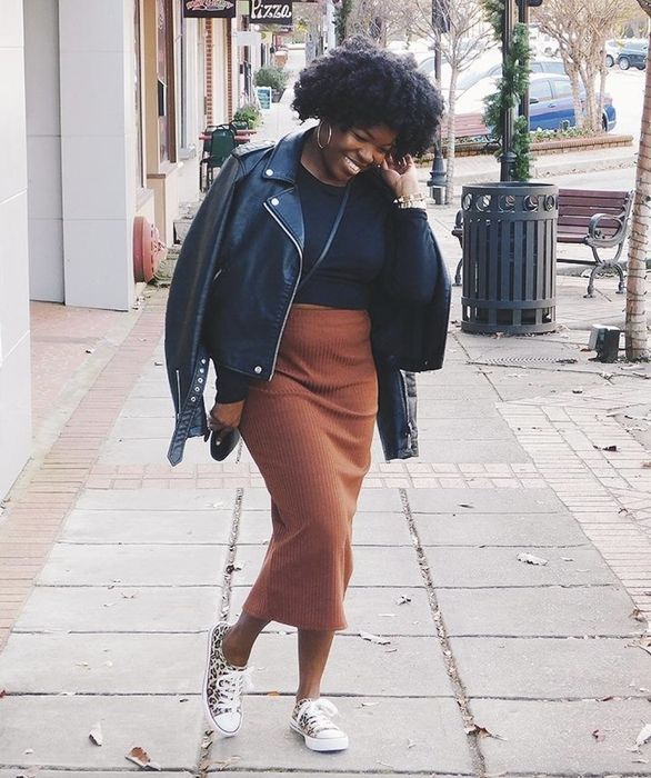 reviewer wearing the orange midi skirt