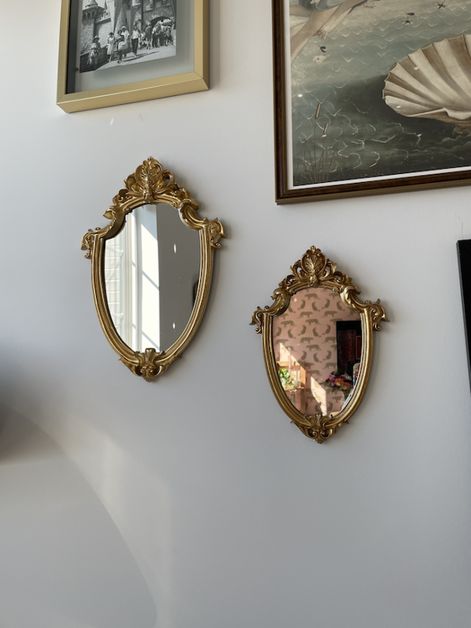 two mirrors beautifully arranged on a gallery wall
