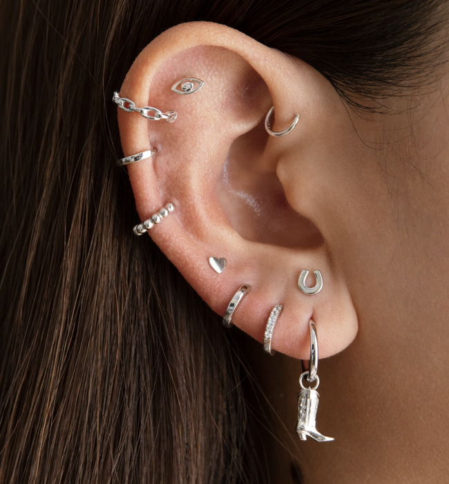 cowboy huggie earring styled with other earrings