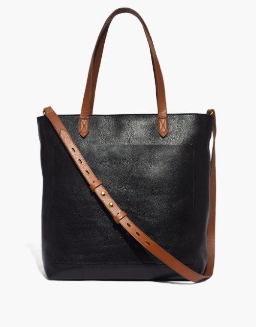 a black tote with brown leather handles and a matching brown crossbody strap