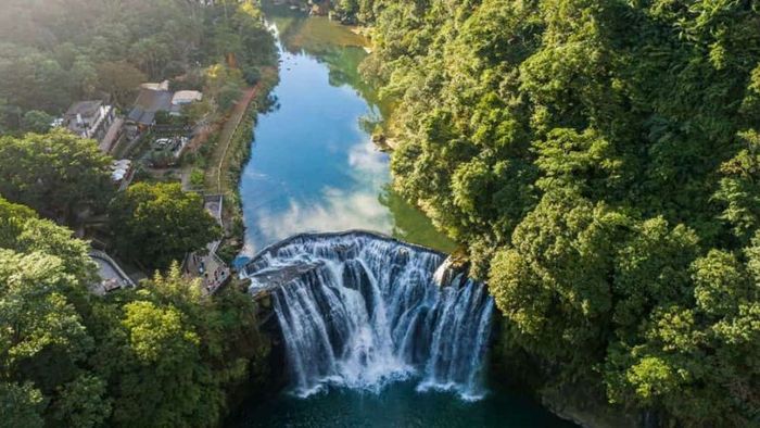 The waterfall is encircled by a virgin forest
