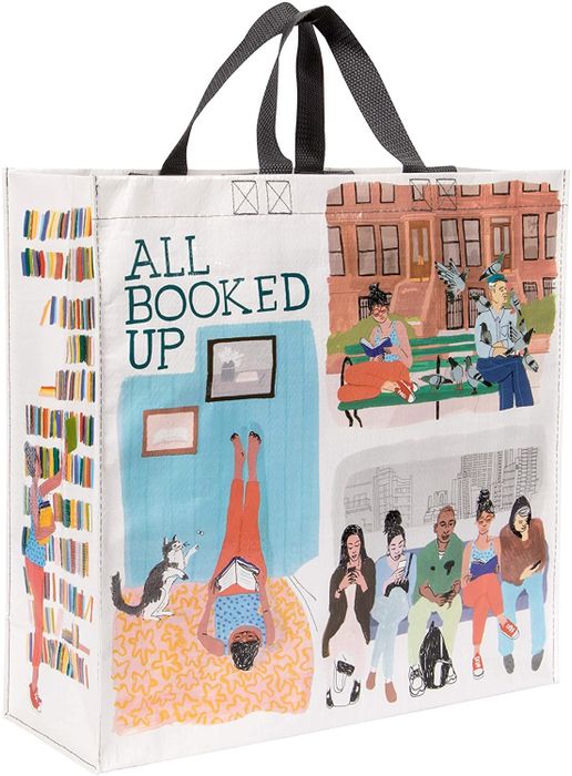 The bag featuring various illustrations of people reading in different settings, accompanied by the text "all booked up"