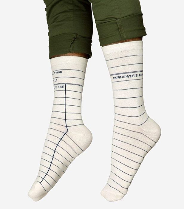 The white socks featuring lines and text like "author, title, due date" to mimic library checkout cards