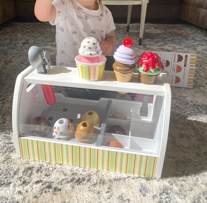 A reviewer's child playing with the ice cream cones