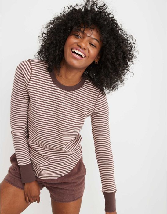 model wearing a brown and cream striped long-sleeve tee with a round neckline