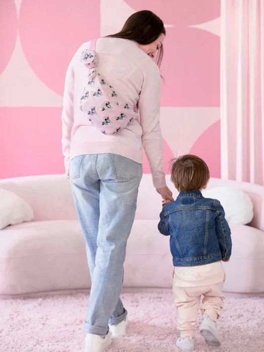 A model showcasing the stylish pink Minnie Mouse sling bag