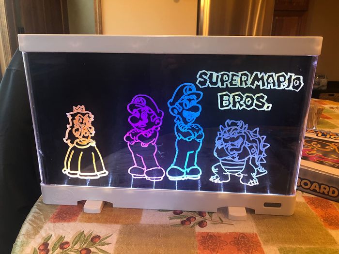 A reviewer's photo showcasing their drawing glowing on the light board