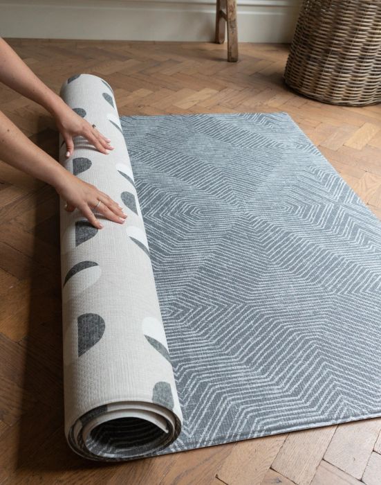 A rubberized reversible play mat with a stylish design