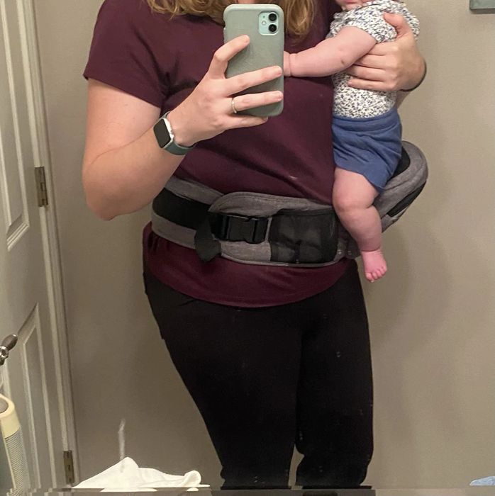 A reviewer provides a close-up view of the carrier, highlighting its convenient front pocket.