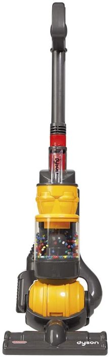A yellow vacuum with a grey handle and colorful balls inside the clear cylinder