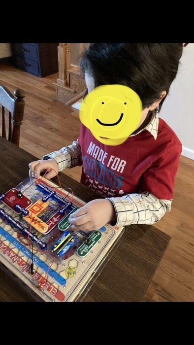 A photo from a reviewer showing their child experimenting with the parts on a plastic grid