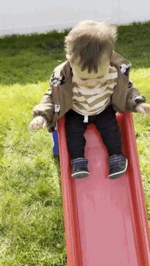 A Mytour editor’s son gleefully sliding down a Little Tikes slide