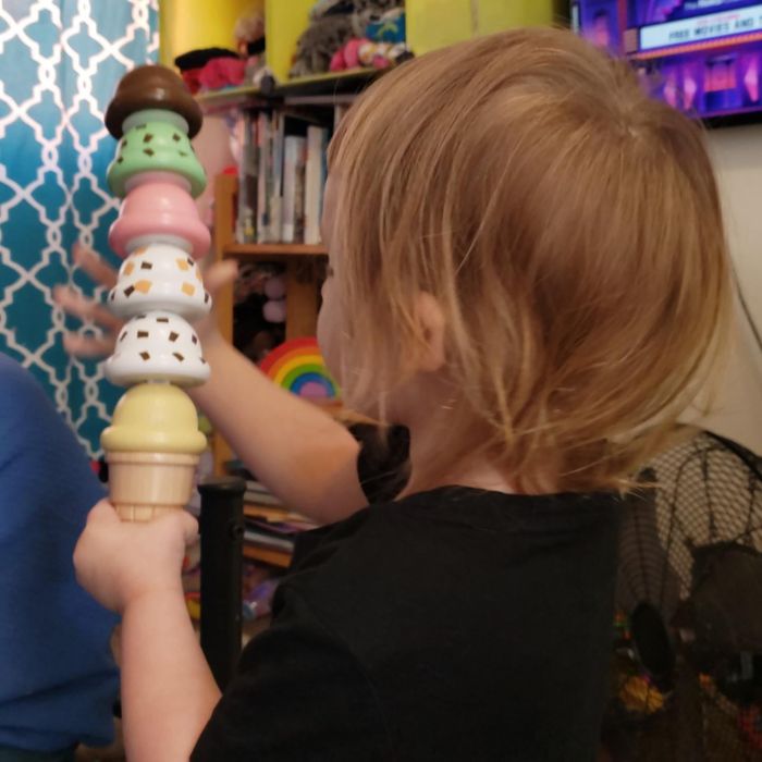 A reviewer’s child enjoying playtime with the ice cream scoops