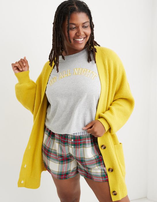 model wearing a vibrant yellow long knit cardigan with tortoiseshell buttons