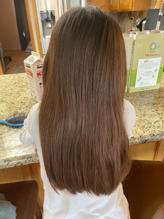 A reviewer’s after photo showcasing smooth, tangle-free hair after using the brush