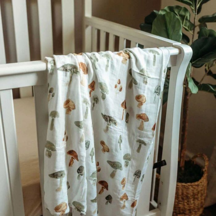 A swaddle blanket with a playful mushroom print