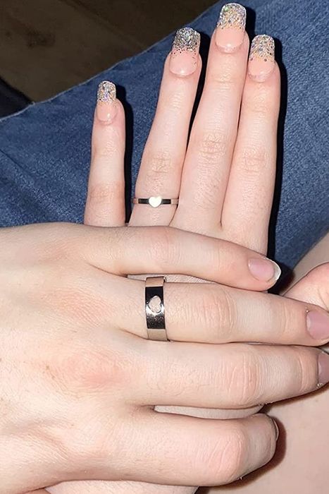 A picture of individuals proudly showcasing their promise rings