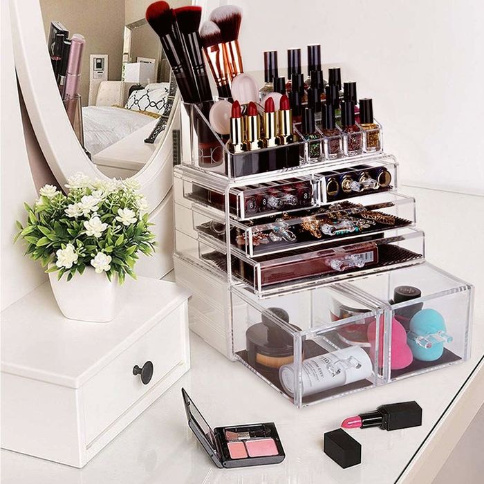 The organizer features four rows of drawers and a dedicated top section for lipsticks, brushes, and nail polishes.