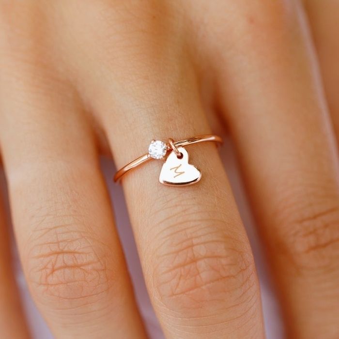 A photo of a model proudly wearing the rose gold ring