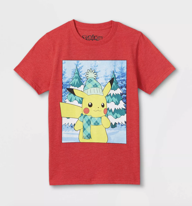 A red tee featuring Pikachu in a snowy forest, wearing a hat and scarf.