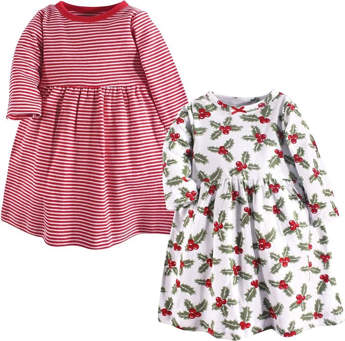 one red striped dress, one white dress featuring holly accents
