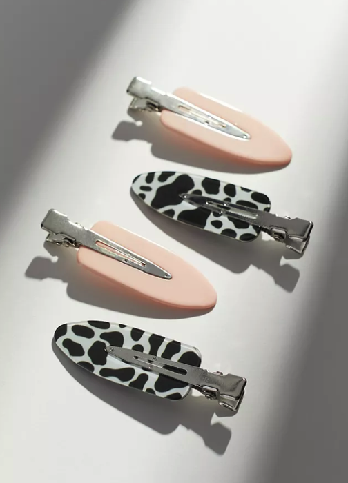 the hair clips in light pink and cow print designs