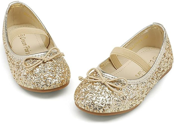Gold flat shoes covered in glittering sparkles.