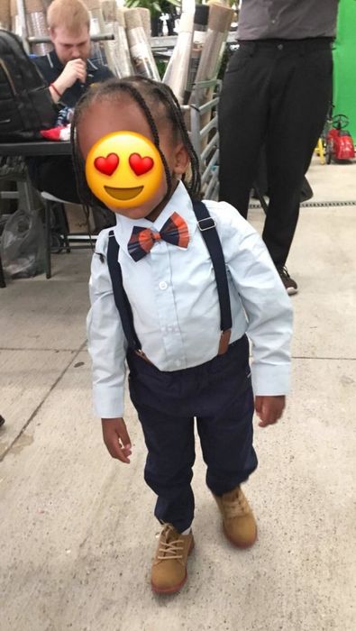 a child dressed in a classic look with a dress shirt, suspenders, a bow tie, and pants