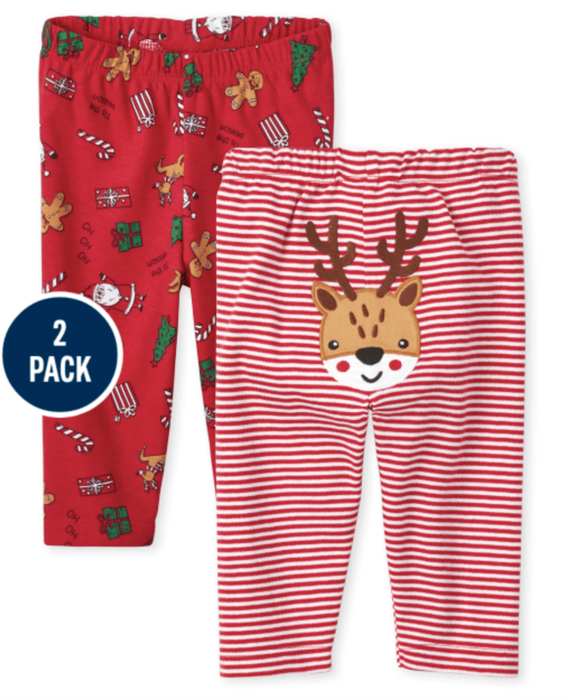 A pair of red pants adorned with Christmas icons and a pair of red striped pants with a reindeer design on the back.