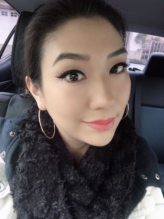 a reviewer wearing the rose gold hoops