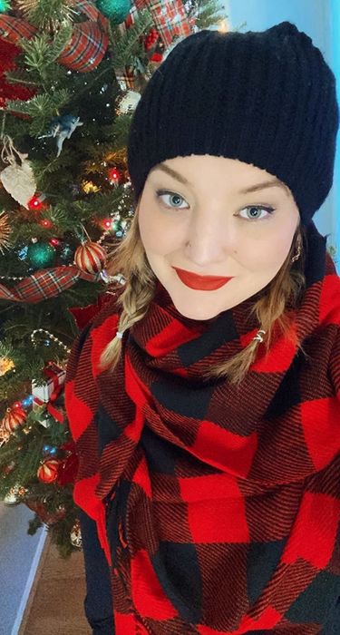 a reviewer’s selfie showcasing the red and black scarf in use
