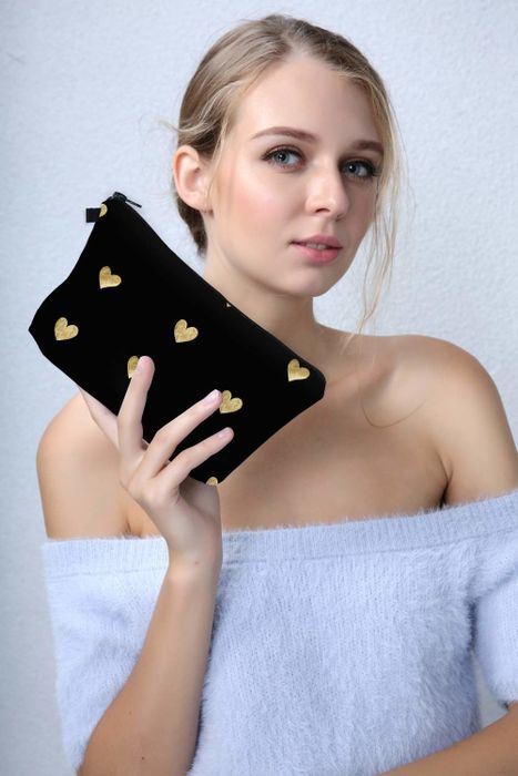 a model showcasing the pouch in hand