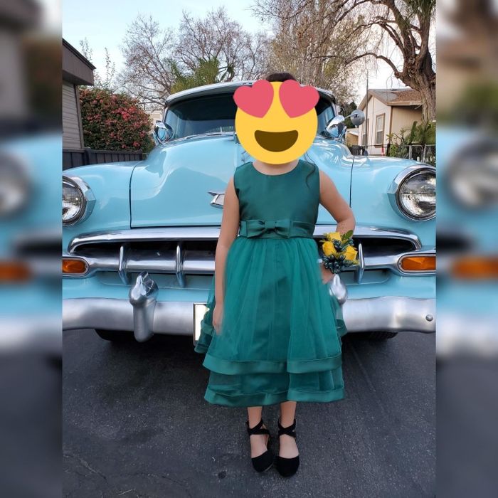 A reviewer's child wearing a layered tank dress with a bow belt.