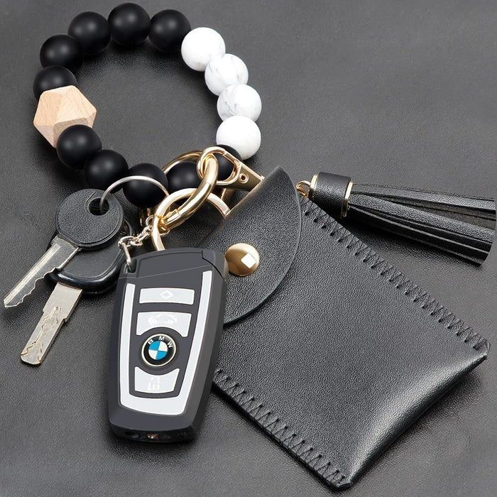 the keychain in black paired with a black and white beaded bracelet